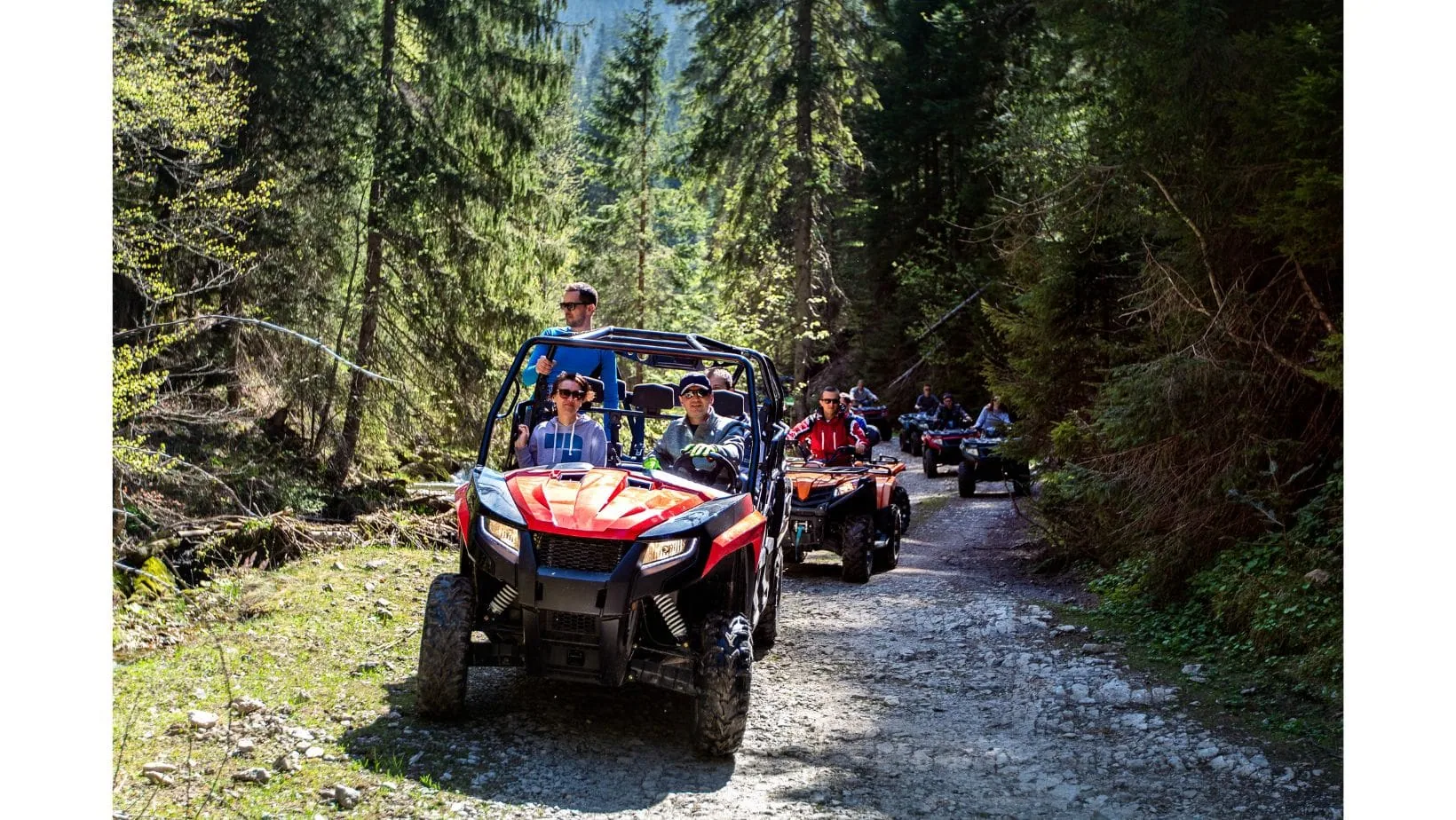 Riders travelling on off-road all-terrain vehicles
