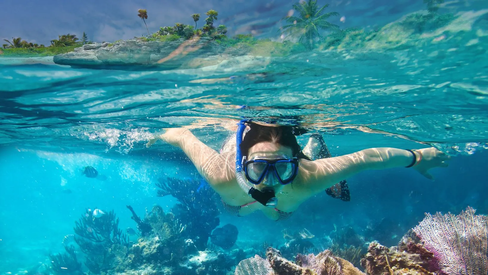 Person snorkelling in clear water